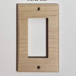 May include: A light wood wall plate with a single rectangular opening and two small holes. The plate is labeled "MAPLE".