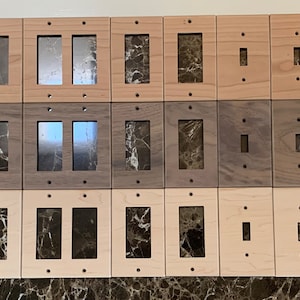 May include: A set of 30 wooden wall plates in various wood tones, including light and dark wood. The plates are designed for electrical outlets and light switches. Some plates have single openings, while others have double openings.