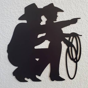Dad and son metal wall decor hanging on a wall.
