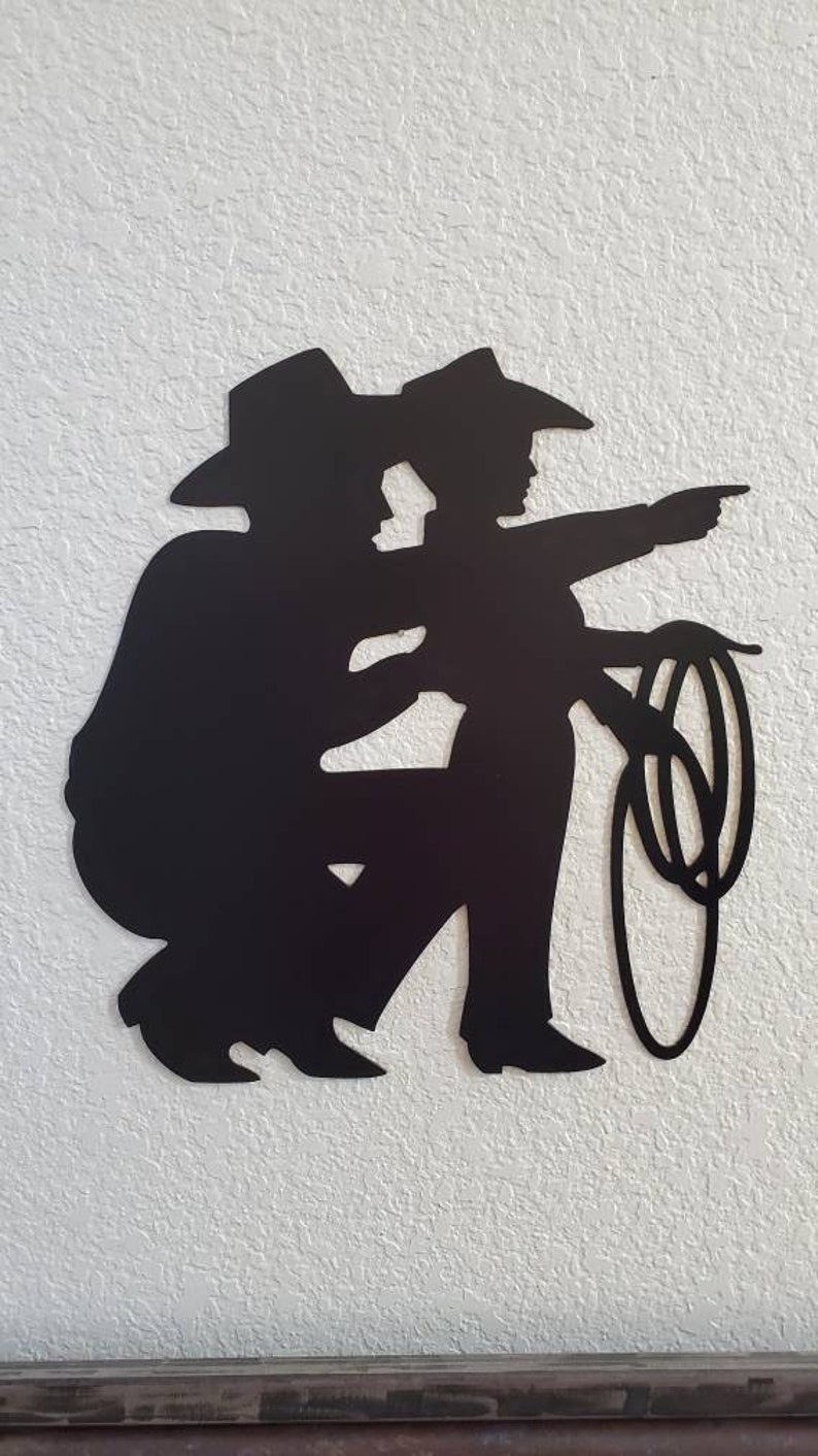 Dad and son metal wall decor hanging on a wall.