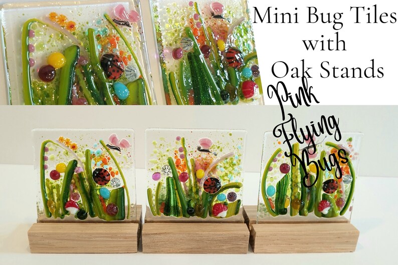 May include: Three small glass tiles with colorful images of flying bugs and flowers on oak stands. The tiles are titled "Pink Flying Bugs" and "Mini Bug Tiles with Oak Stands".