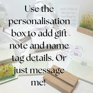 May include: A collection of small glass art pieces with floral designs, displayed on wooden stands. The image includes instructions for adding a personalized gift note and name tag. The text reads "Use the personalization box to add gift note and name tag details. Or just message me!"