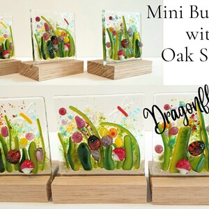 May include: Five miniature glass tiles with colorful depictions of a garden scene with ladybugs, flowers, and dragonflies. Each tile is mounted on a small wooden stand. The tiles are titled "Mini Bug Tiles with Oak Stands Dragonflies".