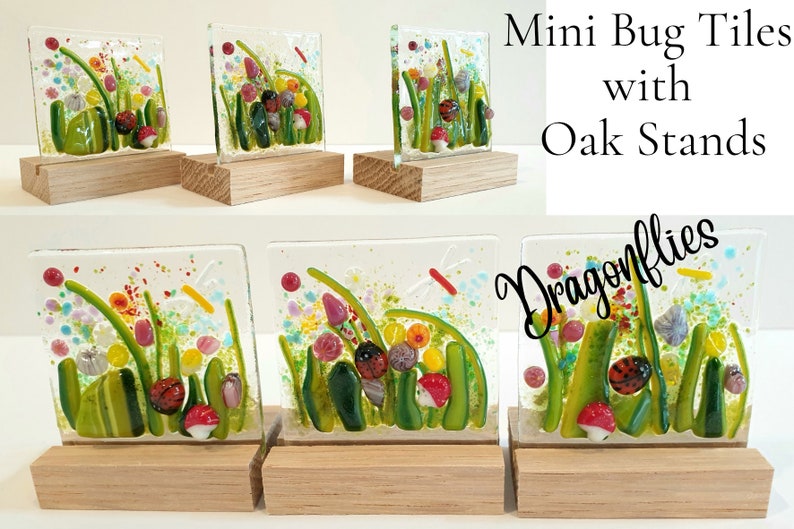 May include: Five miniature glass tiles with colorful depictions of a garden scene with ladybugs, flowers, and dragonflies. Each tile is mounted on a small wooden stand. The tiles are titled "Mini Bug Tiles with Oak Stands Dragonflies".