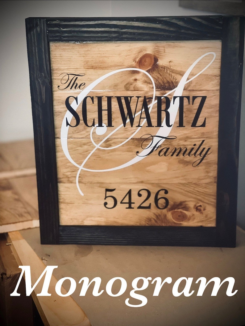 May include: Wooden family name sign with a black frame. The sign features the name "SCHWARTZ Family" in a stylish font, with the address "5426" below. The word "Monogram" is at the bottom.