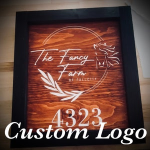 May include: Custom logo sign with a black frame. The sign features the text "The Fancy Farm of Fallcity" with a horse illustration and the number "4323" in white on a stained wood background.