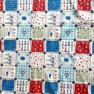 May include: A patterned fabric in red, white, and blue, featuring nautical motifs. The design includes anchors, lighthouses, and sailboats arranged in squares. Ideal for crafting projects, the fabric has a maritime theme.