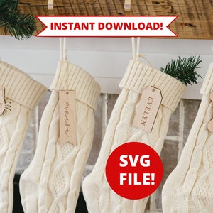 May include: Four white knitted Christmas stockings with personalized wooden tags. The tags are shaped like a cat, a banner, a rectangle, and a bone. The text on the tags reads "Lucy", "Maite", "Evelyn", and "Lucy". The text "INSTANT DOWNLOAD!" and "SVG FILE!" are also visible in the image.