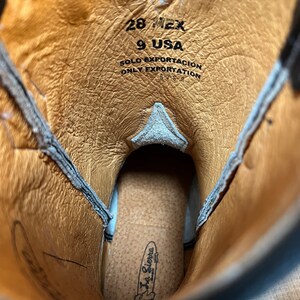 May include: Close-up of the inside of a brown leather cowboy boot with the text "28 MEX 9 USA SOLO EXPORTACION ONLY EXPORTATION" and a La Sierra Boots label.