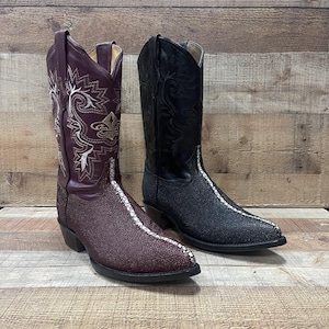 May include: Two pairs of cowboy boots with a unique, textured leather design. One pair is burgundy with white stitching and the other pair is black with white stitching.