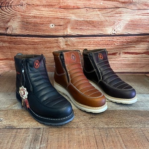 May include: Three pairs of brown, black, and tan leather boots with a zipper on the side. The boots have a quilted design and a white sole.