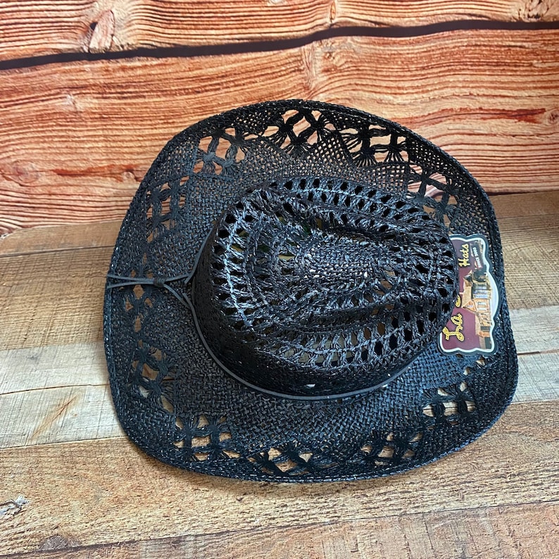 May include: Black straw cowboy hat with a woven design. The hat has a wide brim and a tall crown. The hat is made of a lightweight material and is perfect for summer.