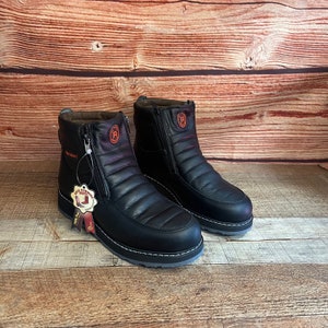 May include: A pair of black leather ankle boots with side zippers and a red logo on the side. The boots have a quilted design and a white rubber sole.