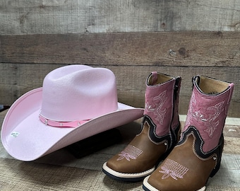 May include: A pair of brown and pink cowboy boots with pink embroidery and a pink cowboy hat.