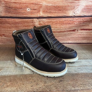 May include: A pair of brown leather boots with a zipper on the side. The boots have a white sole and a brown leather upper. The boots have a small orange logo on the side.