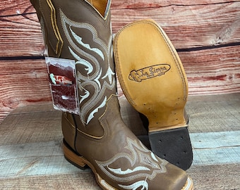 May include: Brown leather cowboy boots with white embroidery and a square toe. The boots have a leather sole and a La Sierra Boots label on the sole.