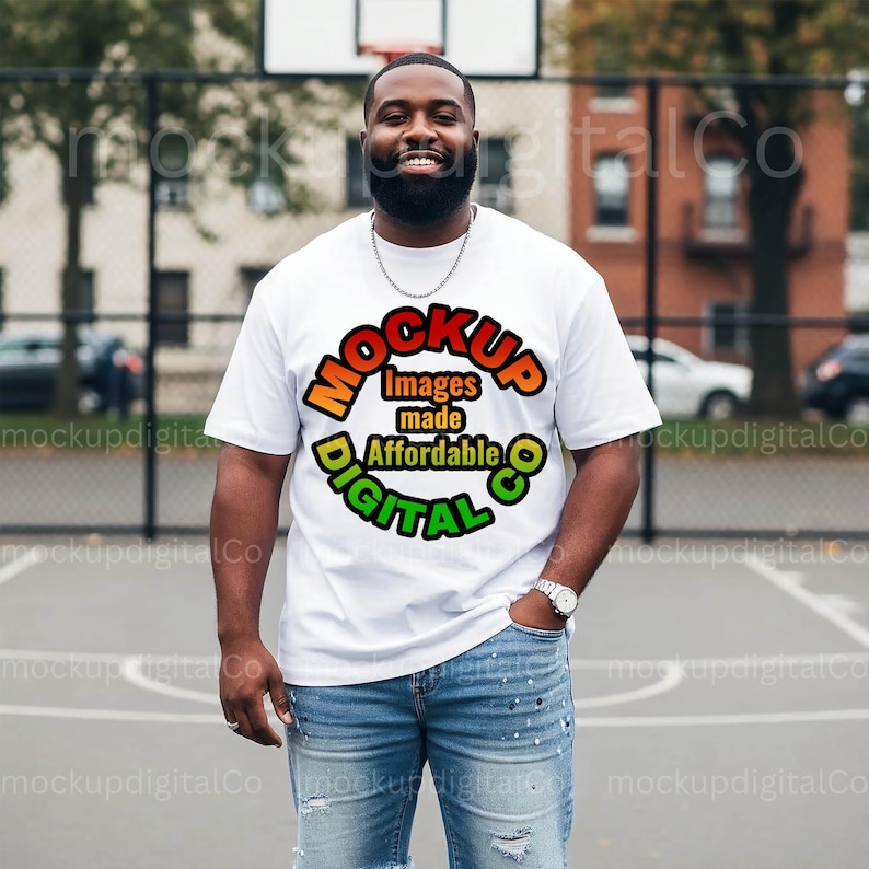 May include: A white t-shirt with the text "MOCKUP Images made Affordable DIGITAL CO" in a colorful design. The person is wearing blue jeans and a silver watch. The background is a basketball court.