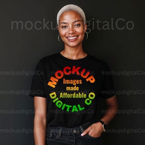 May include: A black t-shirt with the text "Mockup Images made Affordable Digital Co" in a circular design with orange, green, and yellow lettering. The person is wearing a black watch and dark jeans.