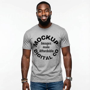 May include: A gray crew neck t-shirt with the text "MOCKUP Images made Affordable DIGITAL CO" in a circular design. The t-shirt is worn by a person wearing blue jeans and a watch.