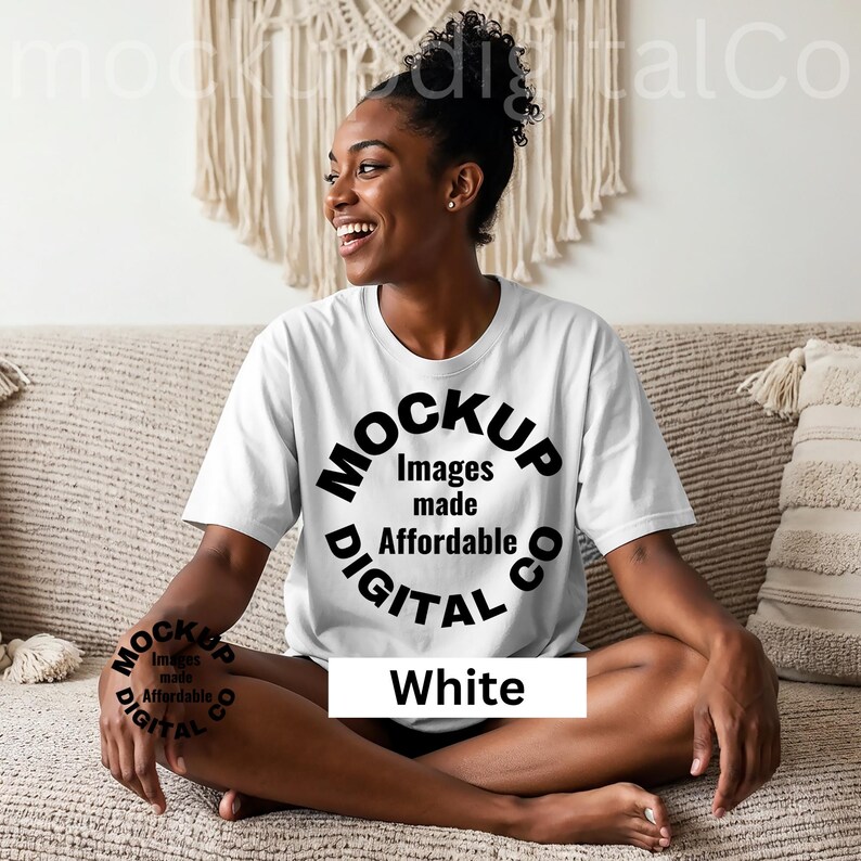 May include: A white t-shirt with the text "MOCKUP Images made Affordable DIGITAL CO" in a circular design. The word "White" is displayed in a white rectangle below the circular design. The person is sitting on a beige couch.