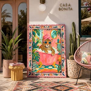 May include: A framed rectangular wall art print featuring a leopard wearing sunglasses and a pink towel on its head while sitting in a pink clawfoot bathtub filled with bubbles, surrounded by tropical plants and a colorful tiled bathroom floor.