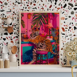 May include: A framed art print depicting a tiger in sunglasses at a bar. The colourful artwork shows a vibrant interior with tropical plants and barware. The tiger is the main focus, giving off a relaxed, cool atmosphere.