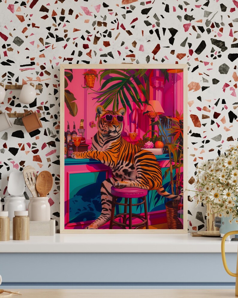 May include: A framed art print depicting a tiger in sunglasses at a bar. The colourful artwork shows a vibrant interior with tropical plants and barware. The tiger is the main focus, giving off a relaxed, cool atmosphere.