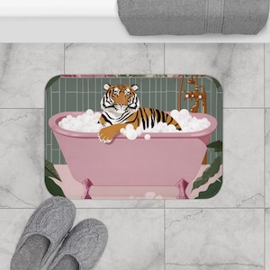 May include: A pink bathtub with a tiger inside, surrounded by bubbles. The bathtub is on a green and pink bath mat with floral accents.
