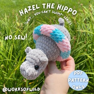 May include: A crocheted gray hippo toy with a pink and blue striped shell. The text "HAZEL THE HIPPO" and "WAIT... YOU CAN'T SWIM?" are visible. The text "NO SEW!" and "PDF PATTERN ONLY" are also present. The toy is held in a hand.