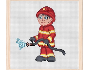 May include: Cross-stitch of a cartoon firefighter in a red uniform with yellow stripes, a red helmet, and black boots. The firefighter is holding a black hose with blue water spraying out. The artwork is framed in a light wood frame.