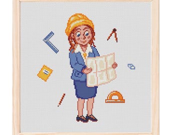 May include: Cross-stitch artwork of a female architect holding blueprints, wearing a blue suit and yellow hard hat. Various drafting tools and a notepad float around her. The artwork is framed in a light wood frame.