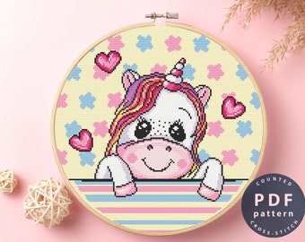 May include: Counted cross stitch pattern PDF for a cute cartoon unicorn with rainbow hair and big eyes. The unicorn is peeking over a striped border with hearts and flowers on a yellow background. The text "COUNTED PDF pattern CROSS STITCH" is in the lower right corner.