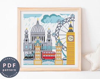 May include: A counted cross stitch pattern featuring iconic London landmarks, including Big Ben, the London Eye, and St. Paul's Cathedral. The pattern is set against a blue sky with rain falling. The pattern is in a wooden frame.