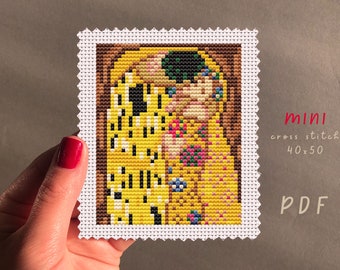 May include: A cross stitch pattern of Gustav Klimt's The Kiss, a famous painting of a couple embracing. The pattern is 40 stitches wide by 50 stitches high. The pattern is available as a PDF download.