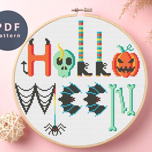 May include: A cross-stitch pattern for a Halloween-themed design featuring the words "Hello" and "ween" with various Halloween icons, including a skull, witch's boots, a pumpkin, bats, a spider, and bones.