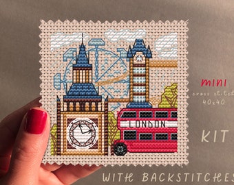May include: A cross stitch kit featuring a miniature depiction of London landmarks, including Big Ben, the London Eye, and a red double-decker bus. The kit includes 40x40 stitches and back stitches.