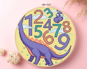 May include: A purple dinosaur with orange spikes on its back is surrounded by colorful numbers 1 through 9 on a yellow background. The numbers are in a pixelated style.
