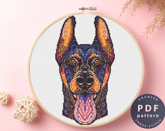 May include: A counted cross stitch pattern featuring a colorful, detailed portrait of a Doberman Pinscher with a floral design. The pattern is available as a PDF download.