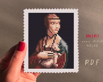 May include: A cross stitch pattern of a woman in a brown and blue dress, with a red background. The pattern is 40 stitches wide by 50 stitches high. The pattern is available as a PDF download.