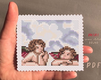 May include: A cross stitch pattern featuring two women with brown hair, sitting with their arms around each other. The pattern is on white Aida cloth and is 50 stitches wide by 40 stitches high. The pattern is labeled "mini cross stitch 50x40 PDF".