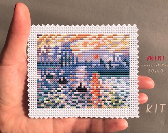 May include: A cross stitch kit featuring a colorful landscape with a sunset. The kit is labeled "mini cross stitch 50x40 KIT".