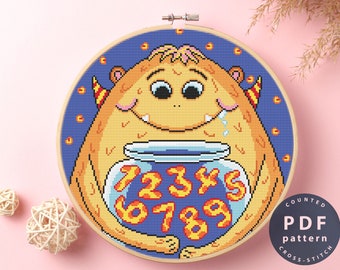 May include: A counted cross stitch pattern featuring a cartoon monster holding a jar with numbers 1 through 9 inside. The monster is yellow with a blue background and has a friendly expression.