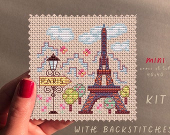 May include: A cross stitch kit featuring a miniature Eiffel Tower with a sign that reads "Paris" and a street lamp. The kit includes back stitches and is 40x40 stitches.