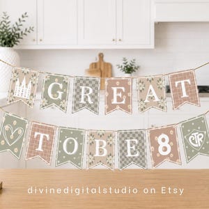 May include: A banner with the words "GREAT TO BE 8" in white letters on decorative pennants. The pennants have floral, plaid, and solid patterns in muted colors. The banner is displayed on a wooden surface.