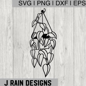 Könnte beinhalten: Schwarze Metall-Hängepflanzensilhouette mit einem Rankenpflanzendesign. Der Pflanztopf ist an einem dreieckigen Rahmen aufgehängt. Das Bild enthält den Text "SVG | PNG | DXF | EPS" und "J RAIN DESIGNS".