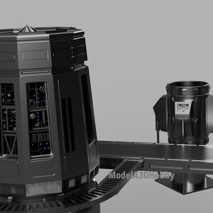 May include: A black, futuristic-looking structure with a cylindrical top and multiple panels. The structure has a series of lights and buttons, and is connected to a smaller, similar structure by a bridge. The text "ModelA3DHobby" is visible.