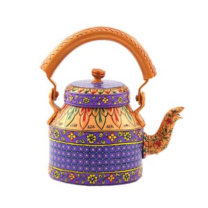 May include: A purple and gold painted metal tea kettle with a wooden handle and a floral design.