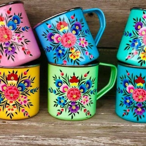 May include: Set of six enamel mugs with floral designs. The mugs are in various colours, including pink, blue, green, and yellow. Each mug features a different floral pattern with vibrant colours.