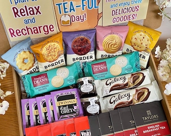 May include: A gift box containing assorted snacks and beverages, including Border biscuits, Dean's shortbread, Galaxy chocolate bars, Twinings Earl Grey tea, Taylors English Breakfast tea, Yorkshire tea bags, and two small jars of preserves with printed cards.