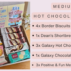May include: A medium hot chocolate box containing four Border biscuits, one Dean's shortbread biscuit, three Galaxy hot chocolate sachets, one Galaxy chocolate bar, and three message cards with text including Today I plan to Relax and Recharge.